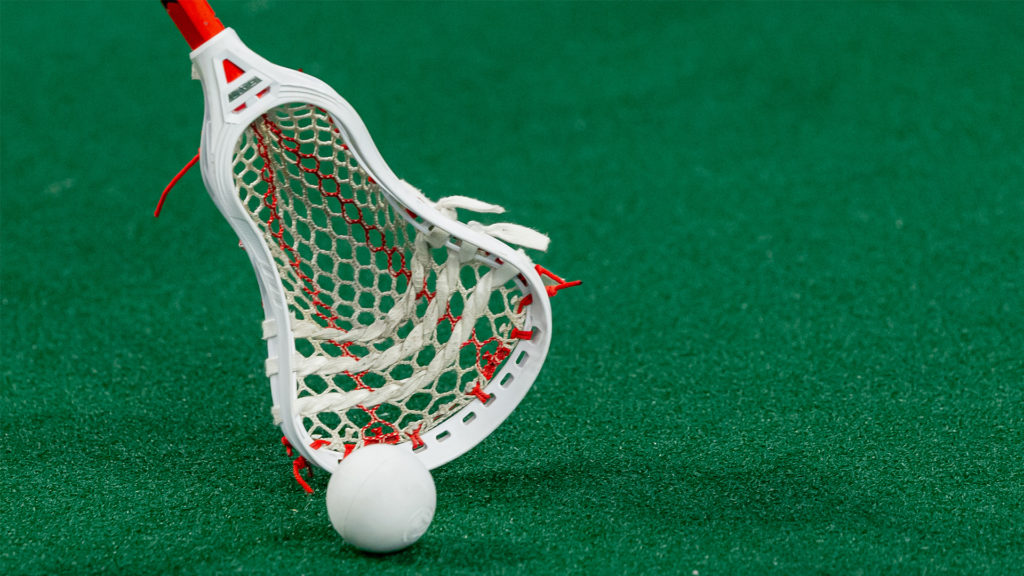 Lacrosse stick on field with ball